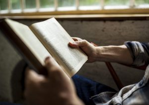 ‘Novus Ordo Seclorum’, Does Predictive Programming Create Reality? Closeup-of-hands-holding-reading-book-PJEE2EM-300x211